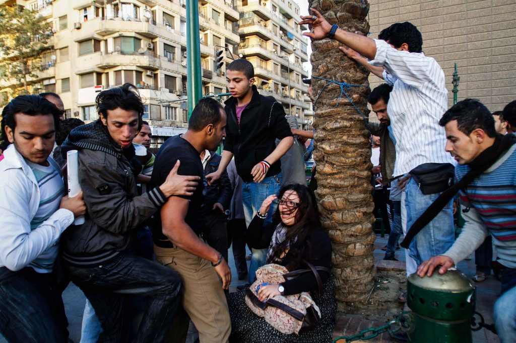 From Eman Helals photo essay Just Stop: Egyptian woman assaulted in Tahir Square, Cairo, during a march for International Womens Day 2011. Some men around her were the harassers and others were trying to rescue her. (CNW Group/Canadian Journalism Forum on Violence and Trauma)