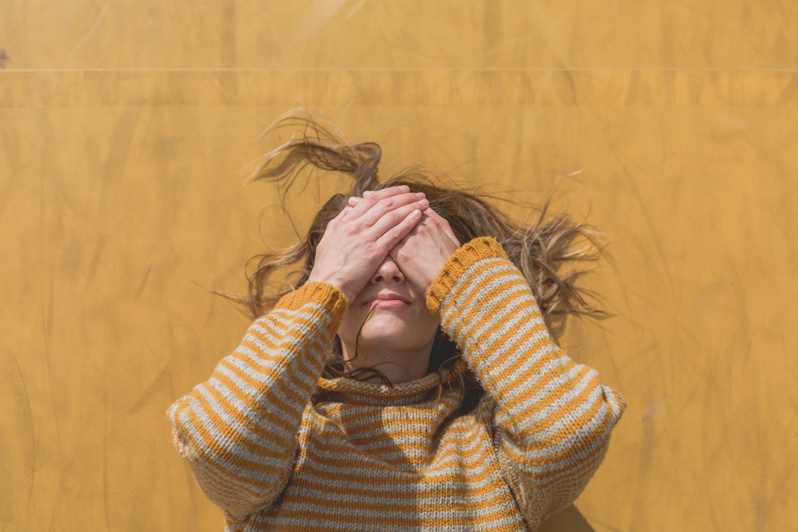 woman in yellow hides face 4460×4460 1 scaled