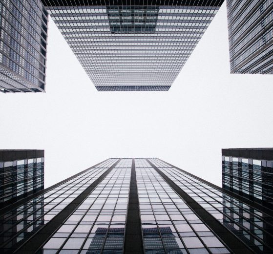 The image shows a worm's eye view of some skyscrapers.