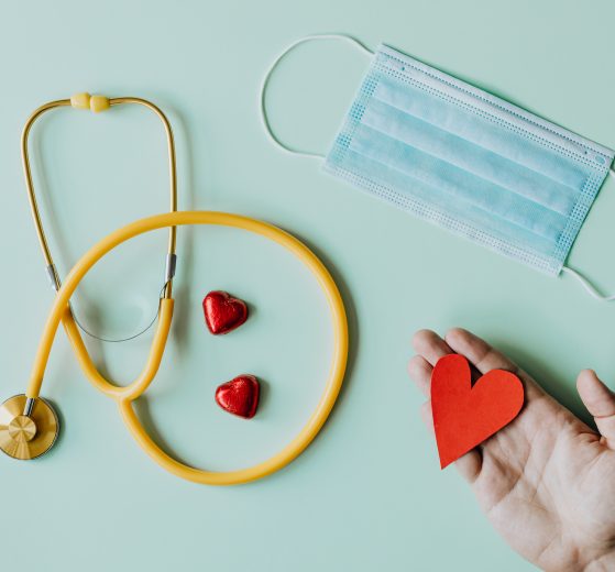 A photograph of a mask, stethoscope, and a paper heart.