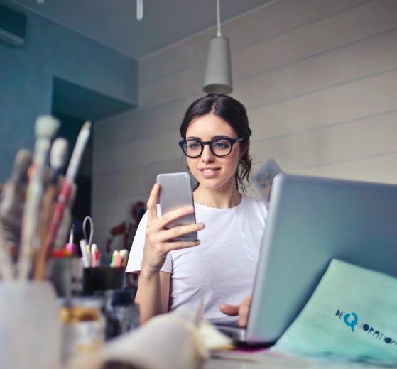 Woman reading phone representing tech tools to combat stress