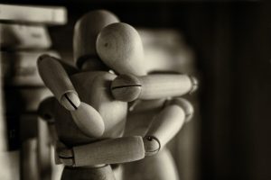 A photo of two mannequins hugging, representing the new normal