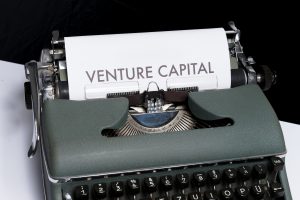 Paper in a typewriter that reads 'venture capital,' representing venture capital funds
