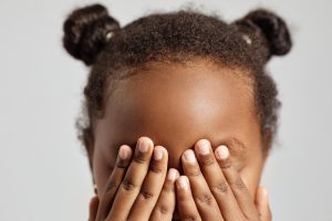 A little girl covering her eyes, representing blind spots