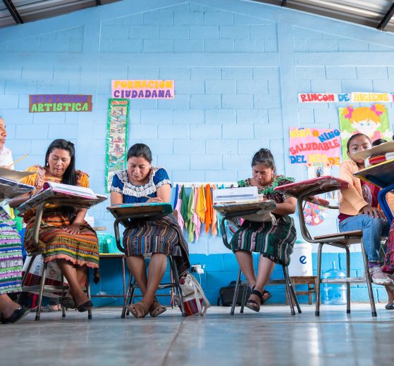 A group of women in Guatemala writing as part of Lancôme's literacy program