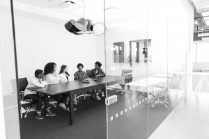 Greyscale photo of people in a boardroom