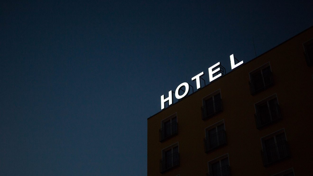 Hotel sign lit up in the night sky