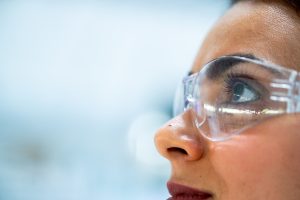 Young woman in goggles looking upwards