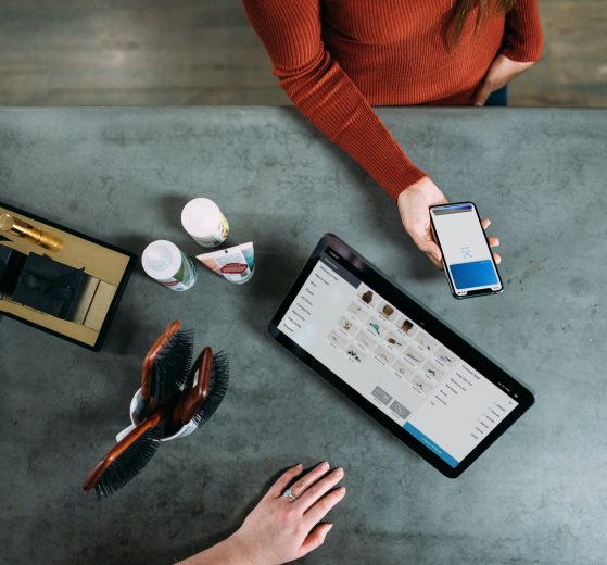 Woman holding smartphone to pay