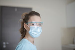 Health care worker in mask looking straight at camera
