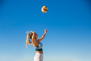 A member of women's sports playing volleyball