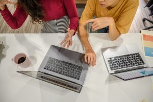Bird's-eye-view of two women on their laptops