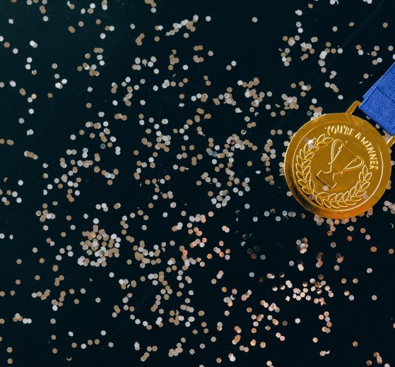 Gold medal with a background of confetti