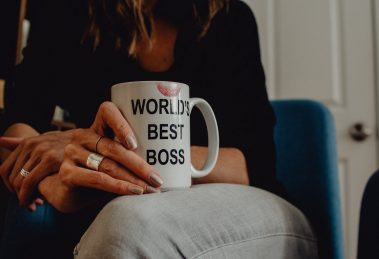Woman holding coffee mug that says "World's Best Boss"