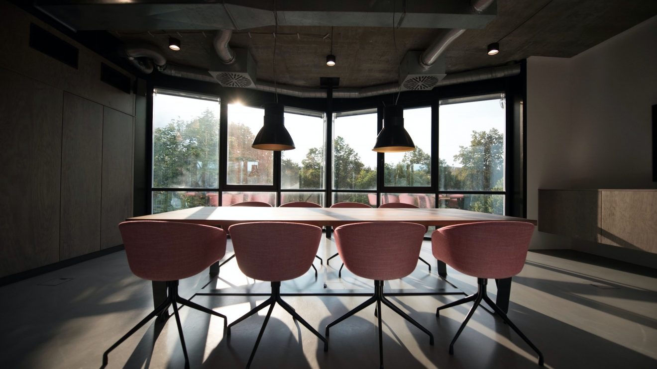 Boardroom with pink chairs