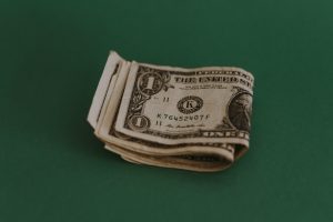 A photo of dollar bills on a green background, representing grants for founders