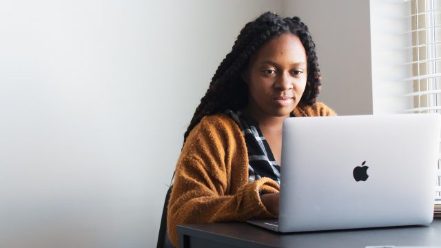 Woman on laptop, representing the online Entrepreneurship Certificate Programme