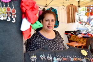 Ledy, a Grameen America member in Oakland and owner of a clothing and jewelry stand