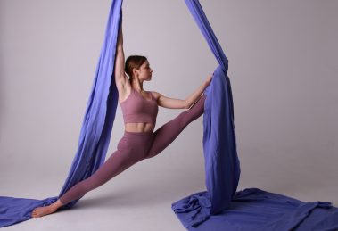 A photo of an aerial dancer with silks, one of the mentioned weird ways to lower stress