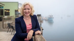 Amy Graves with green building behind her