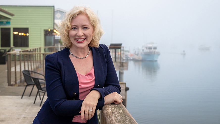 Amy Graves with green building behind her